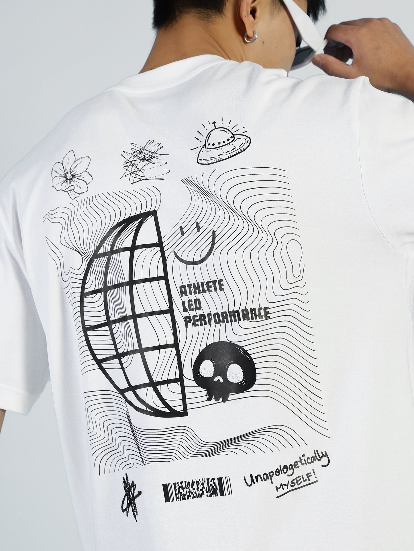 A modern trailblazer sports the Vibe T–Bright White by My Store, a premium cotton-blend mens tee with abstract black line art and bold “ATHLETE LED PERFORMANCE” plus “Unapologetically MYSELF!” printed on the back.