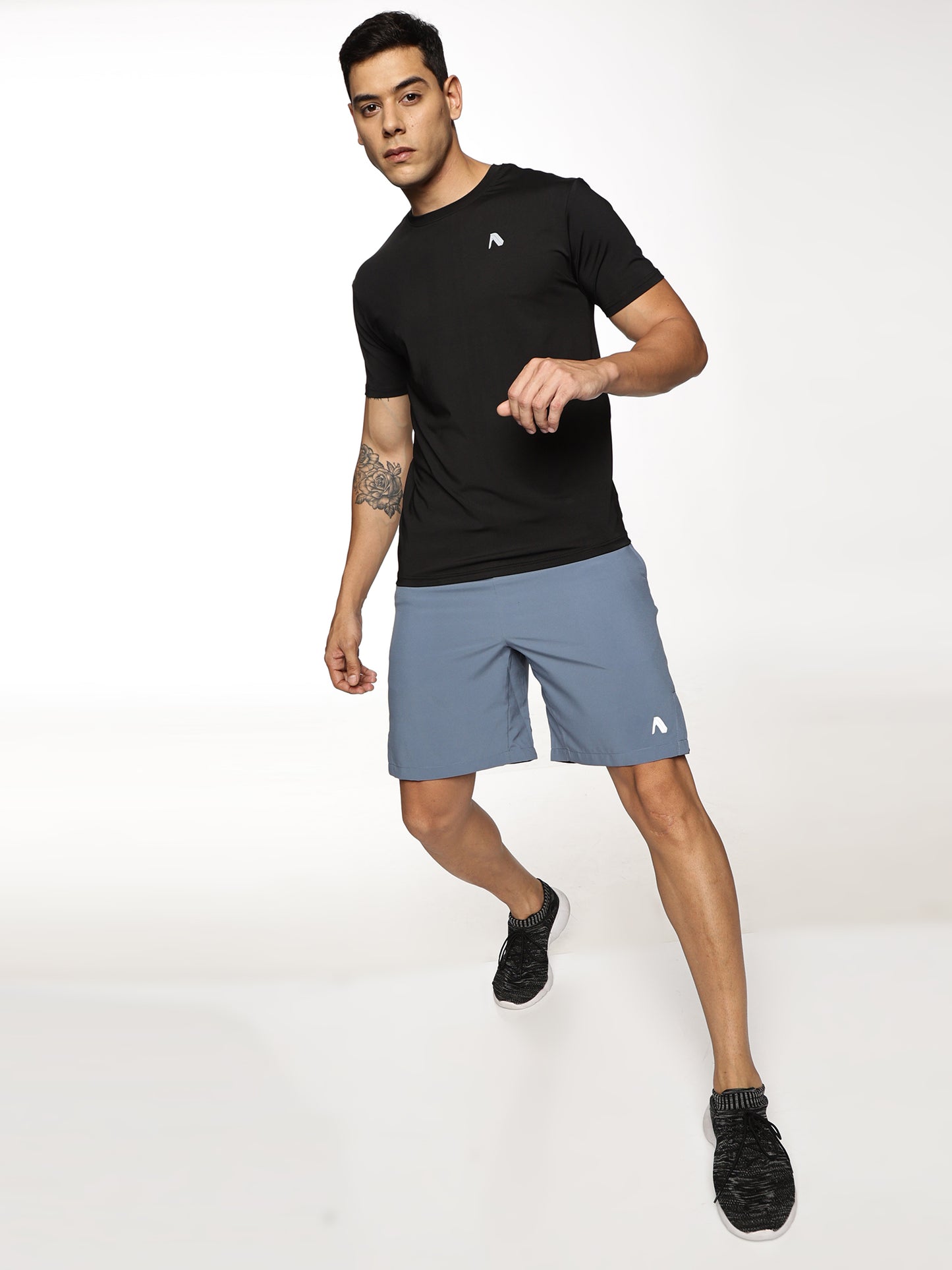 Lifestyle shot of ALP Mode Black Gym T-Shirt paired with other activewear