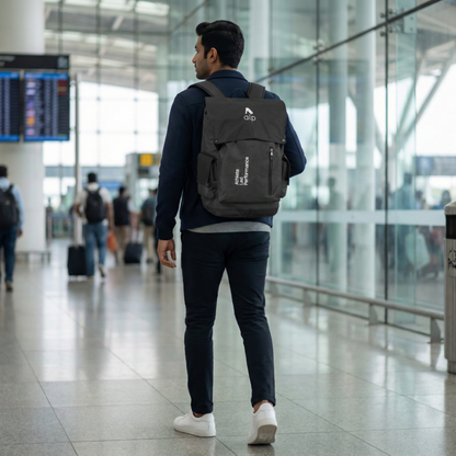 Man with a backpack walking through an airport terminal