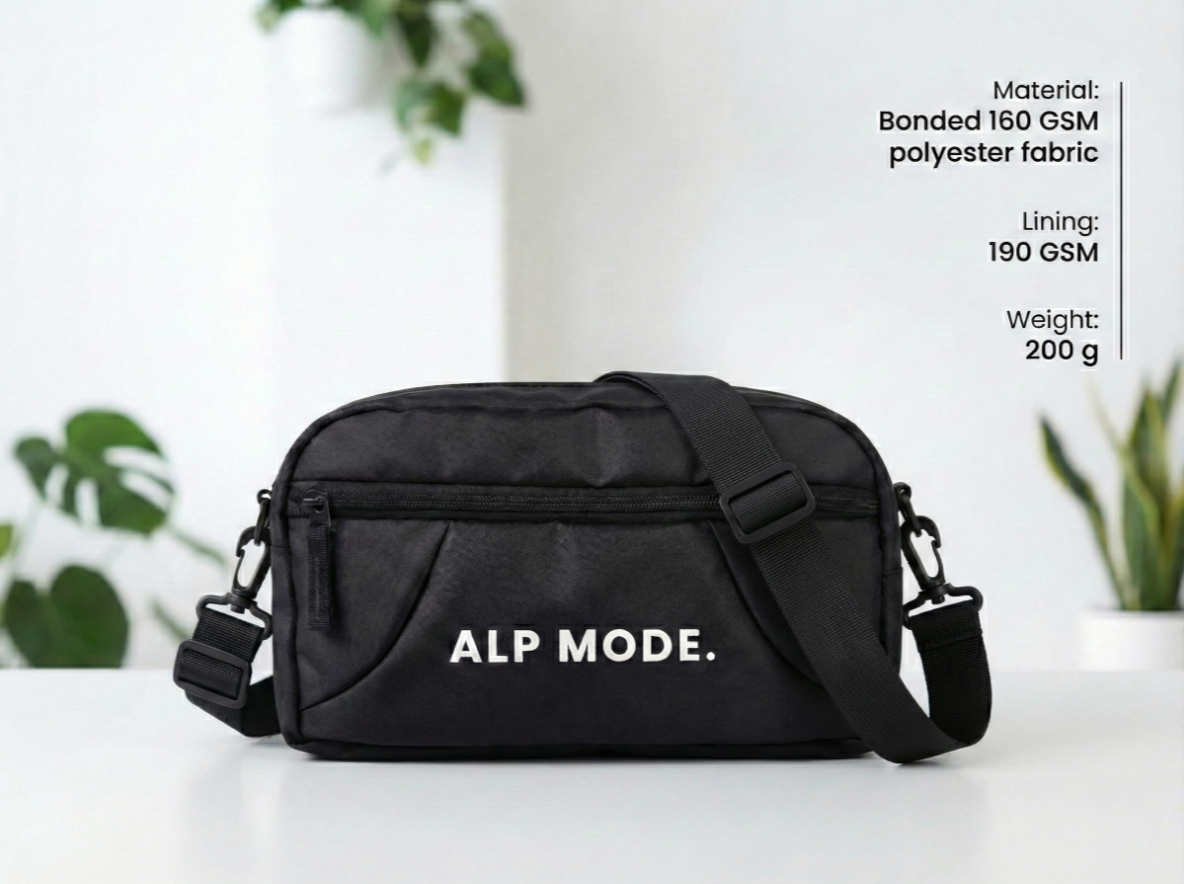 Black bag with 'ALP MODE.' branding on a white surface with plants in the background